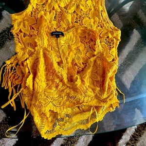 Mustard yellow lace crop top and bracelet.